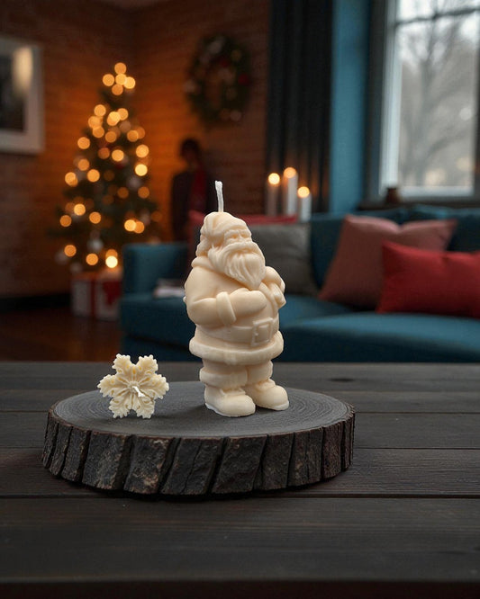 Candle shaped like a Santa Claus figure on a wooden base in a cozy living room setting.