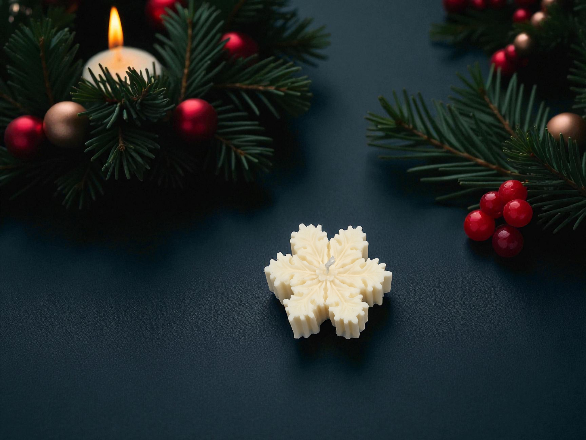 Decorative snowflake candle on a dark surface with Christmas decorations.